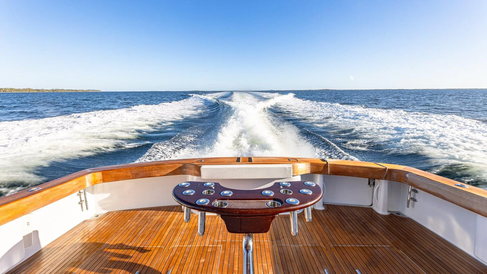 The aft deck offers a stunning view of the open sea with a beautifully crafted wooden fishing station. aboard FIRST BITE Yacht for Sale