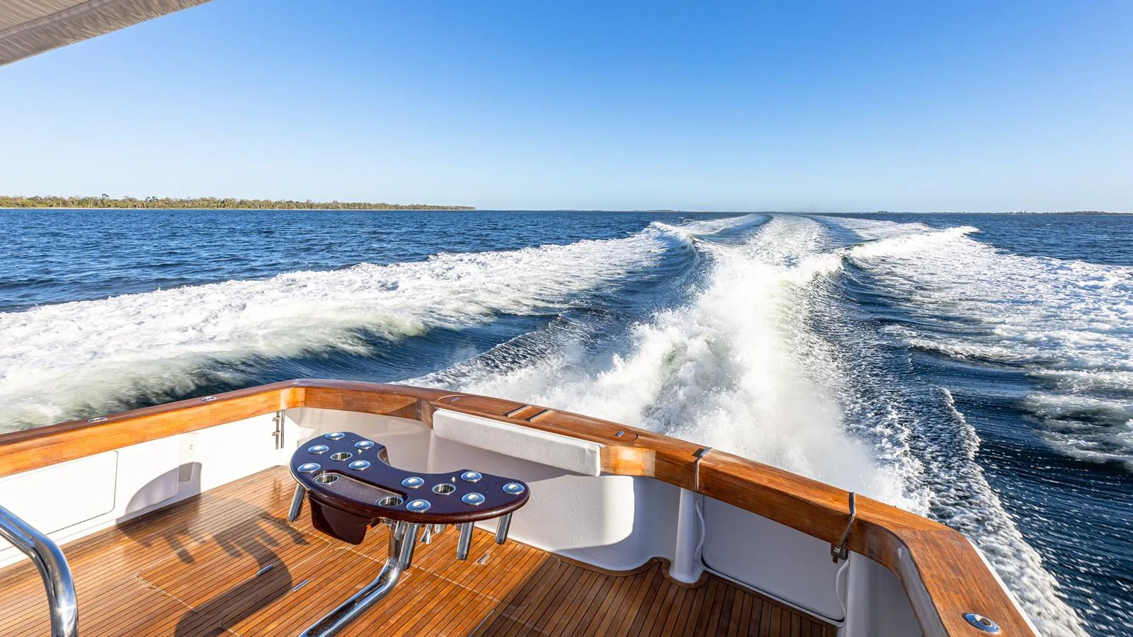 The yacht's aft deck offers a stunning view of the wake as it cruises through the water. aboard FIRST BITE Yacht for Sale