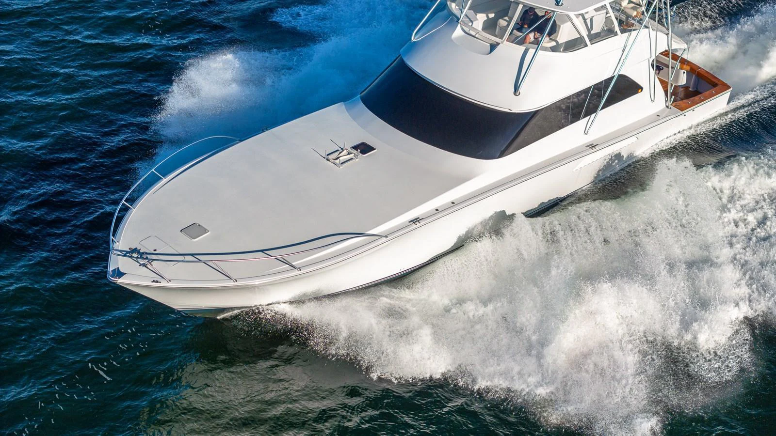 A sleek yacht cuts through the water with impressive speed and elegance. aboard FIRST BITE Yacht for Sale