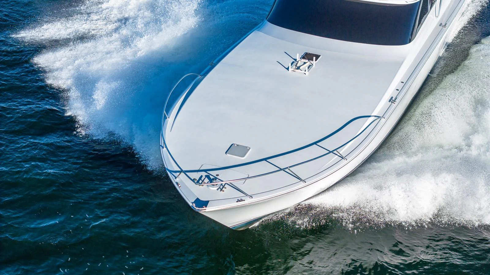 A sleek yacht cuts through the water, showcasing its streamlined design and powerful performance. aboard FIRST BITE Yacht for Sale