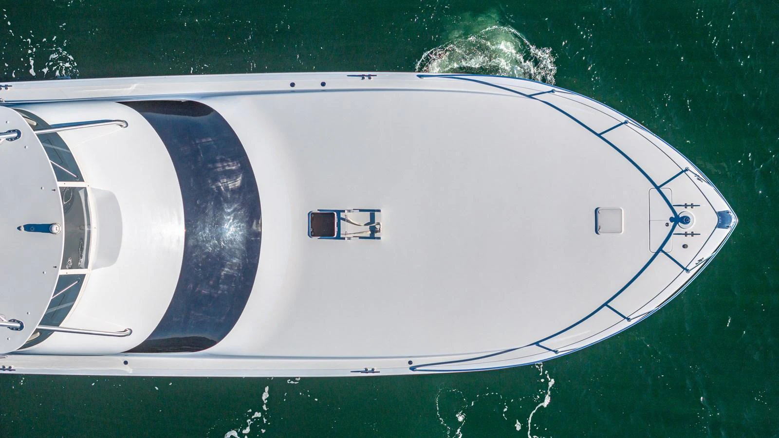 A sleek yacht glides through the water, viewed from above. aboard FIRST BITE Yacht for Sale
