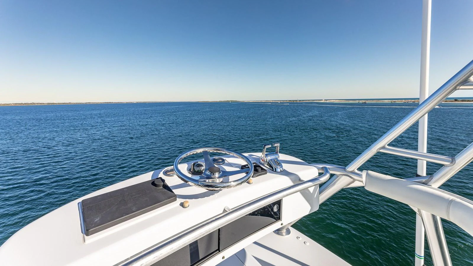 The yacht's helm offers a commanding view over the serene blue waters. aboard FIRST BITE Yacht for Sale