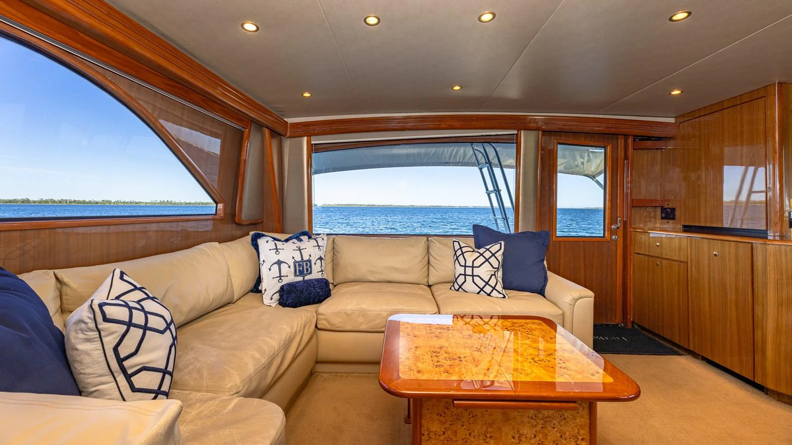 The salon offers a cozy and elegant space with plush seating and a stunning ocean view. aboard FIRST BITE Yacht for Sale