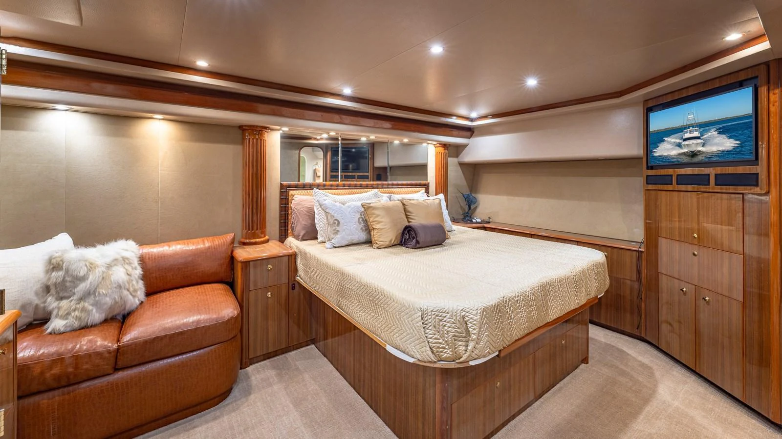 The master stateroom features a luxurious bed, ample storage, and a cozy seating area. aboard FIRST BITE Yacht for Sale