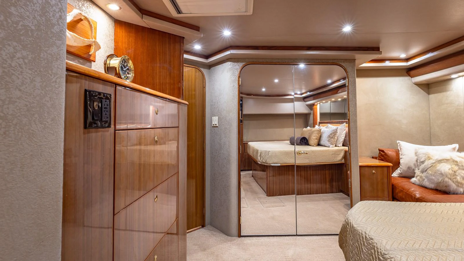 The stateroom features luxurious wood finishes, plush bedding, and ample storage. aboard FIRST BITE Yacht for Sale