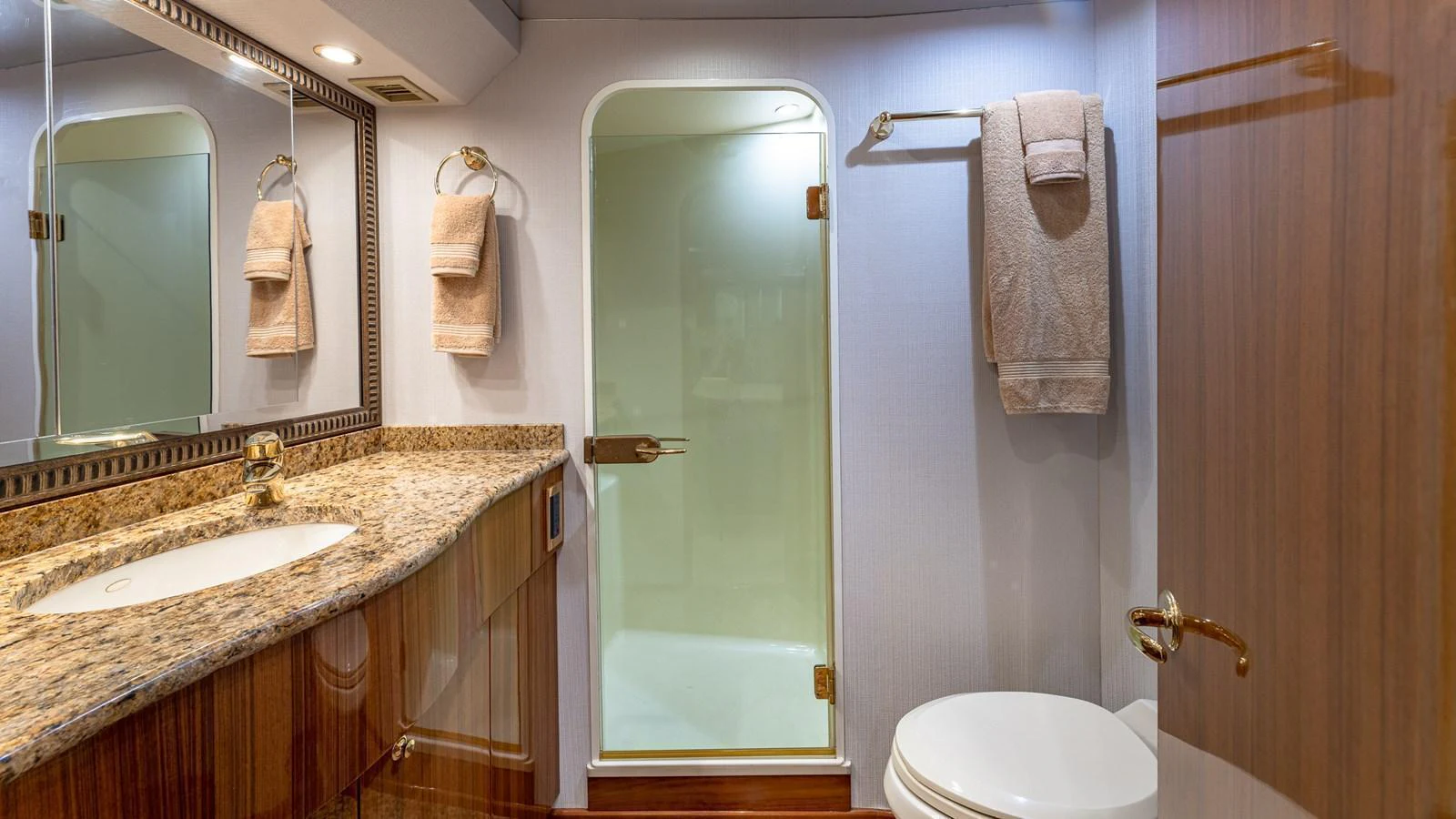The yacht's bathroom features elegant fixtures and a spacious shower area. aboard FIRST BITE Yacht for Sale