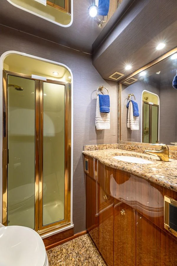 The yacht's bathroom features elegant fixtures and a luxurious granite countertop. aboard FIRST BITE Yacht for Sale