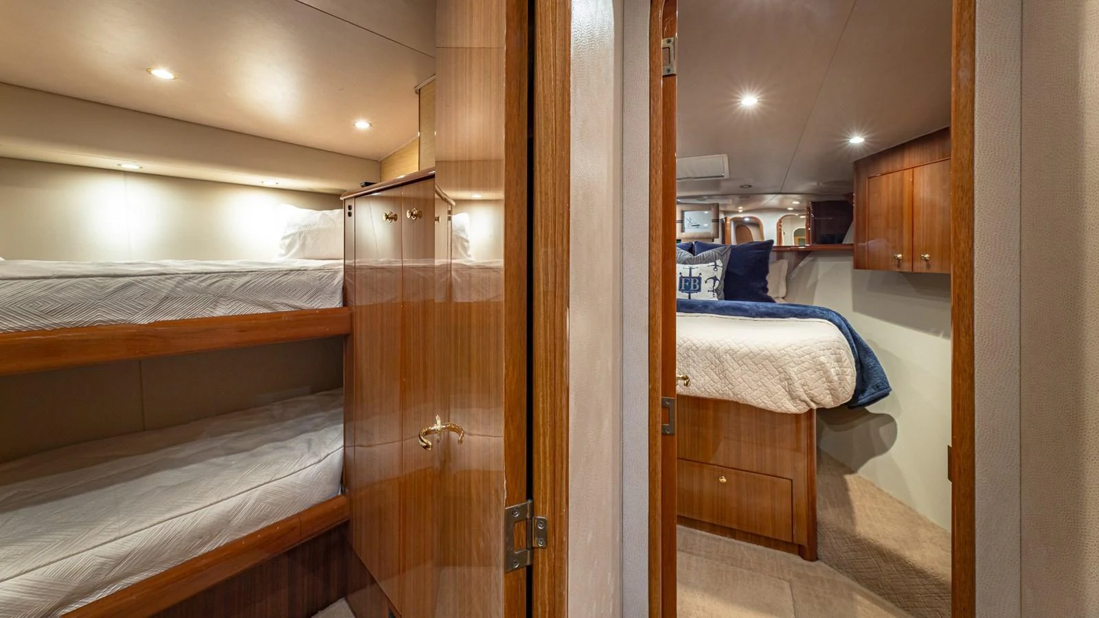 The guest stateroom features cozy bunk beds and a comfortable double bed, offering ample sleeping space. aboard FIRST BITE Yacht for Sale