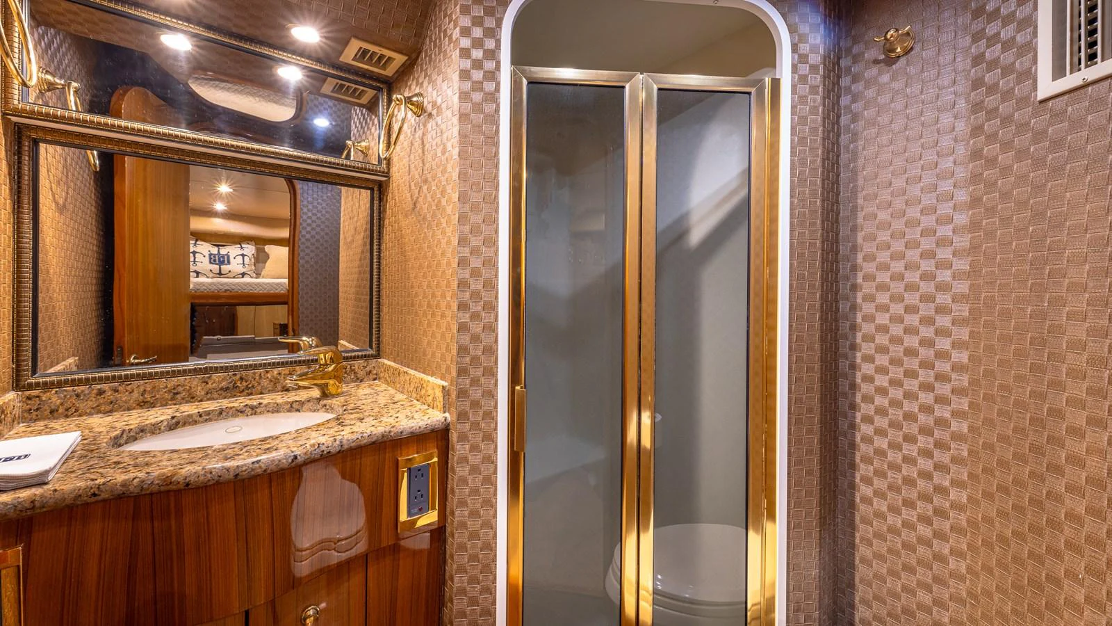 The yacht's bathroom features a luxurious design with a granite countertop and a spacious shower. aboard FIRST BITE Yacht for Sale
