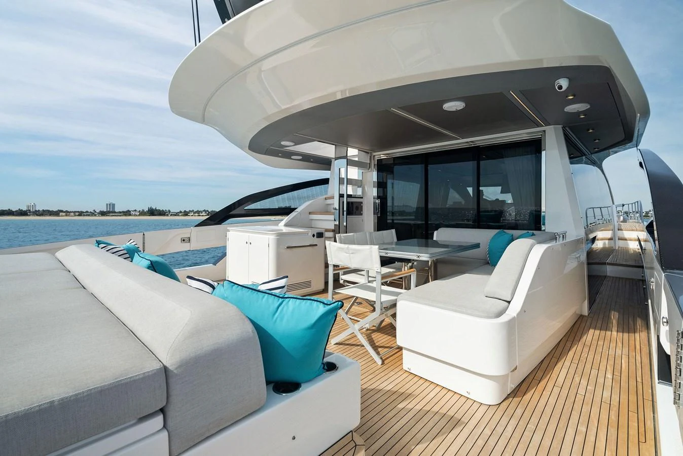 The aft deck offers a spacious and stylish outdoor lounging area with comfortable seating and a dining table. aboard OCEAN'S SE7EN Yacht for Sale