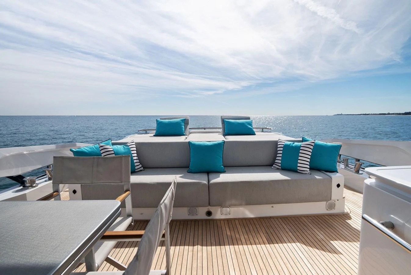 The aft deck offers a spacious and inviting seating area with plush cushions and a stunning ocean view. aboard OCEAN'S SE7EN Yacht for Sale