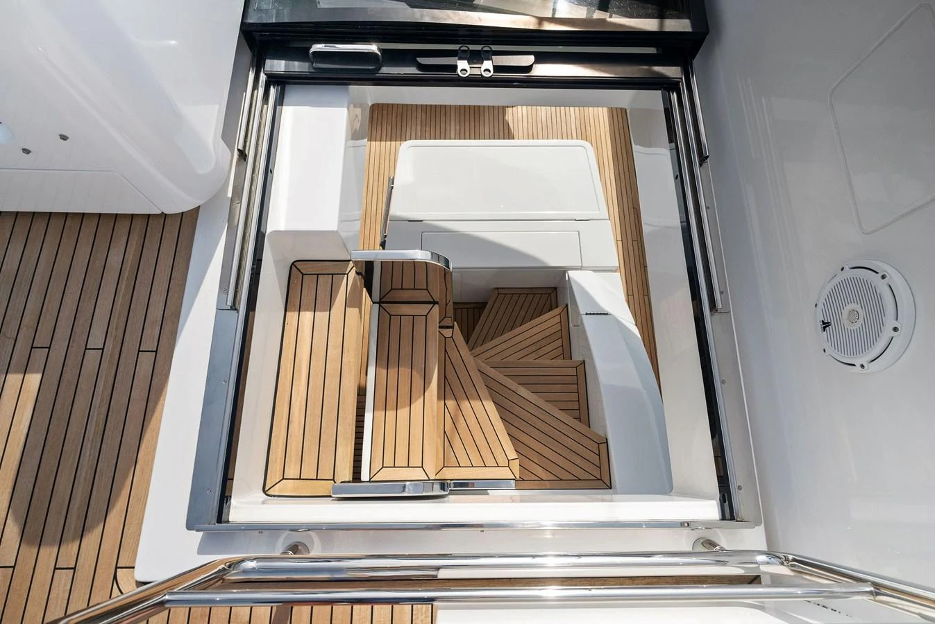 A beautifully crafted wooden staircase leads down to the lower deck, showcasing exquisite design and craftsmanship. aboard OCEAN'S SE7EN Yacht for Sale