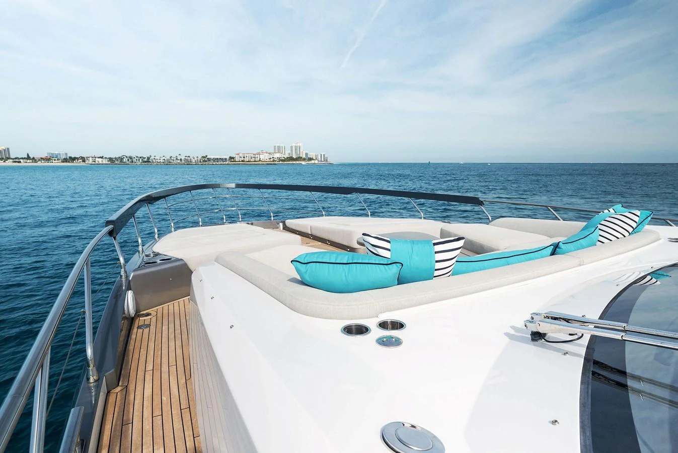 The foredeck offers a spacious sunbathing area with plush cushions and stunning ocean views. aboard OCEAN'S SE7EN Yacht for Sale
