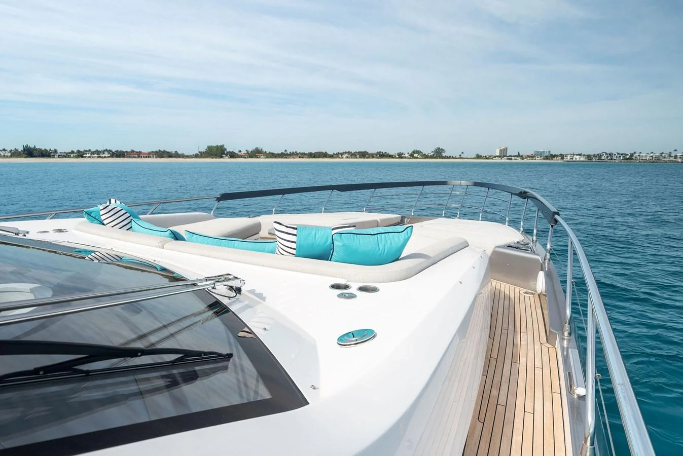 The yacht's foredeck features luxurious sun pads with vibrant turquoise cushions, perfect for relaxation. aboard OCEAN'S SE7EN Yacht for Sale