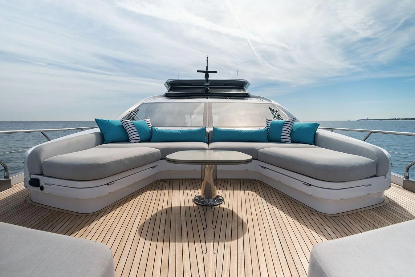 The foredeck features a spacious seating area with plush cushions and a sleek table, perfect for relaxation and enjoying the view. aboard OCEAN'S SE7EN Yacht for Sale