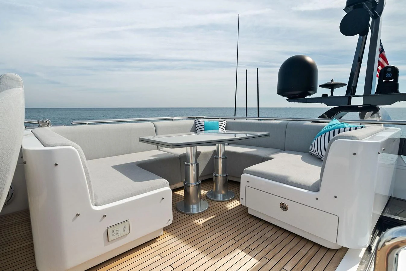 The aft deck features a stylish and comfortable seating area with a table, perfect for outdoor relaxation. aboard OCEAN'S SE7EN Yacht for Sale