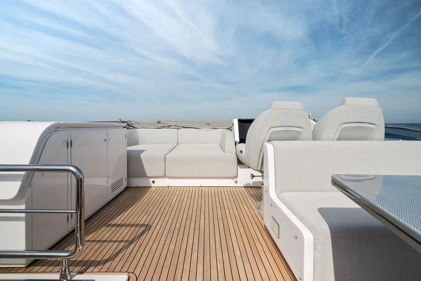 The flybridge offers a spacious and comfortable outdoor seating area with a sleek, modern design. aboard OCEAN'S SE7EN Yacht for Sale