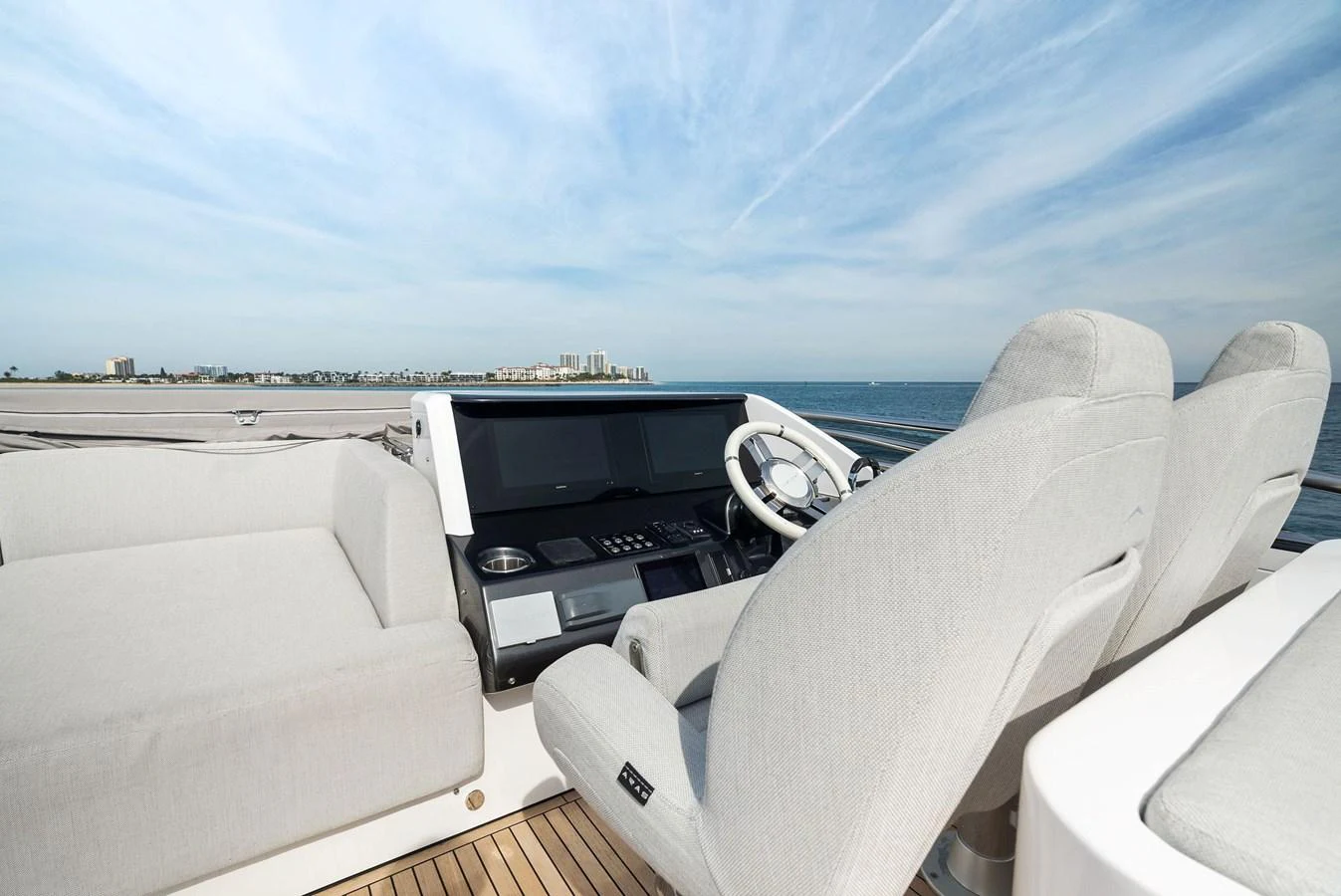 The helm station offers a sleek and modern design with comfortable seating and advanced navigation equipment. aboard OCEAN'S SE7EN Yacht for Sale