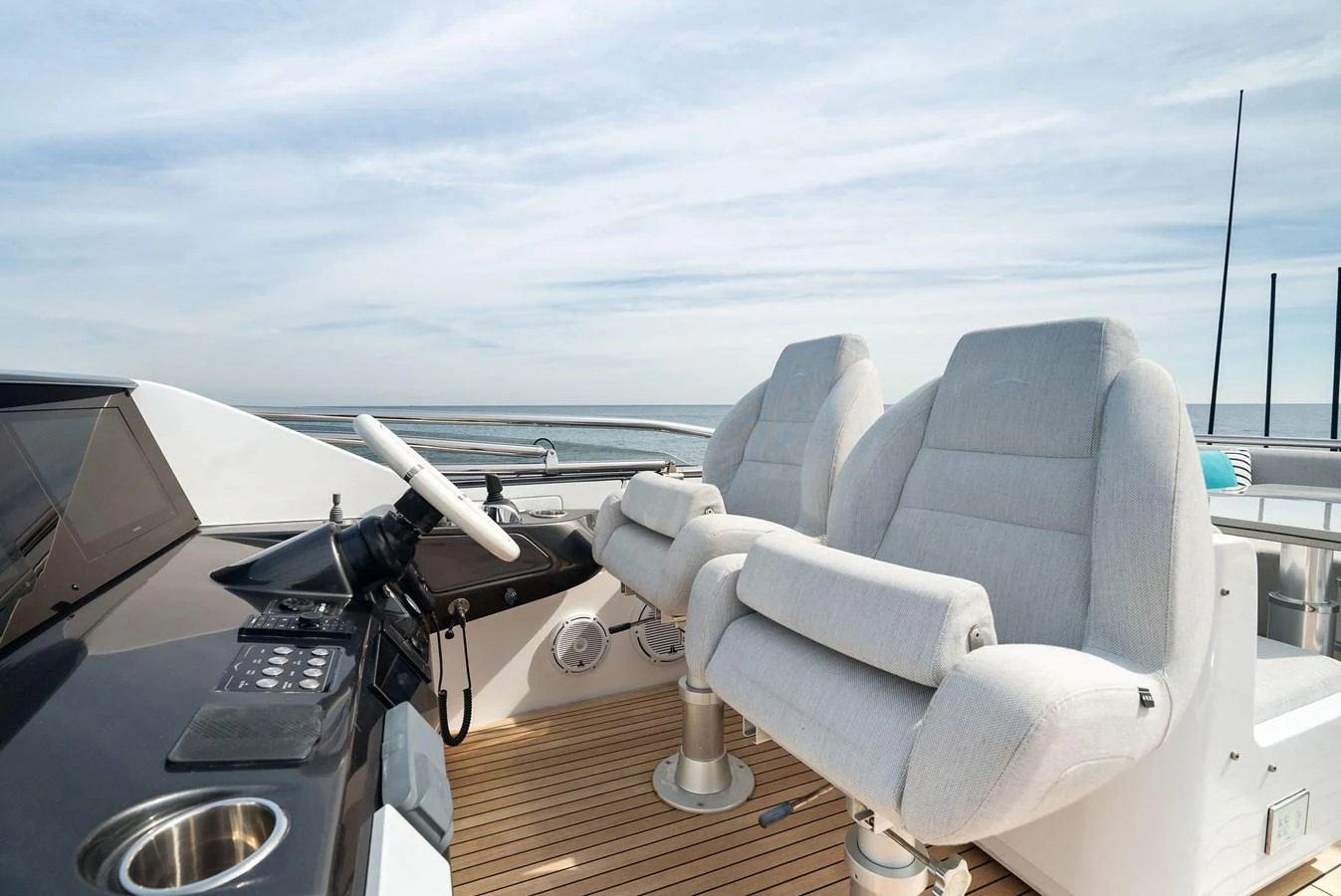 The yacht's helm features plush, comfortable seating with a modern control panel. aboard OCEAN'S SE7EN Yacht for Sale