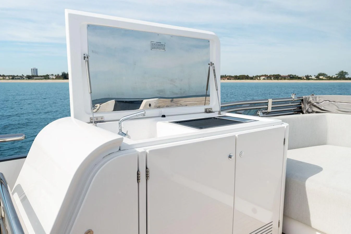 A sleek wet bar on the deck of a yacht, perfect for outdoor entertaining. aboard OCEAN'S SE7EN Yacht for Sale