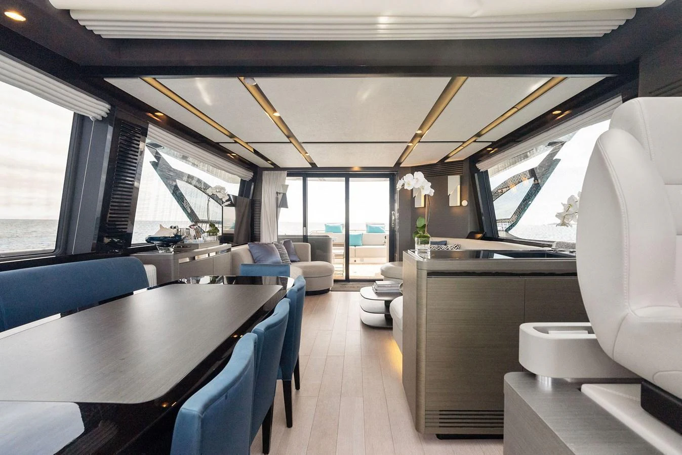 The yacht's salon features a spacious and elegant seating area with modern furnishings. aboard OCEAN'S SE7EN Yacht for Sale