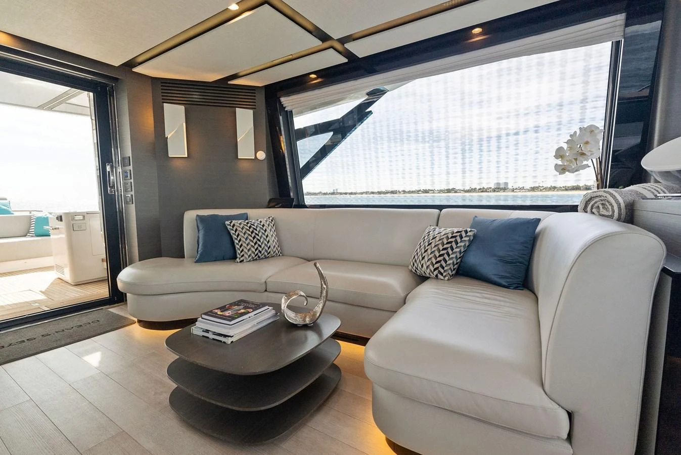 The salon features a modern and comfortable seating area with stylish decor and ample natural light. aboard OCEAN'S SE7EN Yacht for Sale