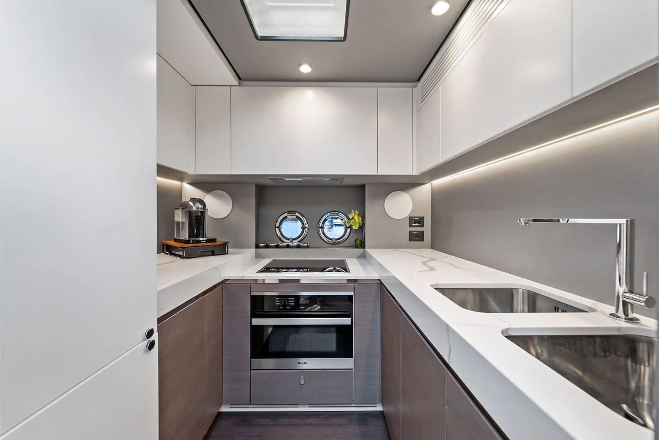 The modern galley features sleek cabinetry, high-end appliances, and ample counter space. aboard OCEAN'S SE7EN Yacht for Sale