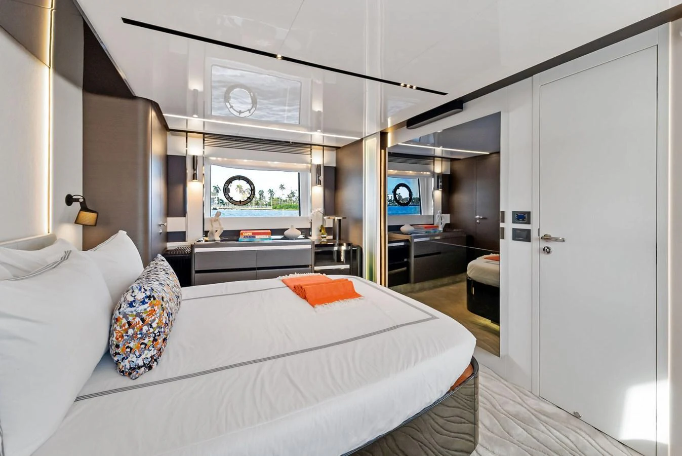 A luxurious stateroom featuring a large bed, modern decor, and a scenic window view. aboard OCEAN'S SE7EN Yacht for Sale