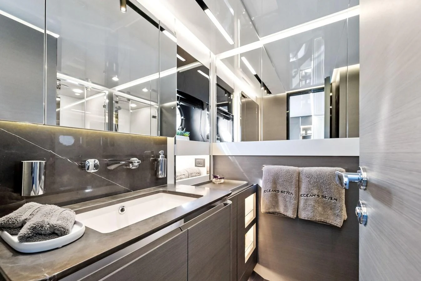 A sleek and modern yacht bathroom with elegant fixtures and ample lighting. aboard OCEAN'S SE7EN Yacht for Sale