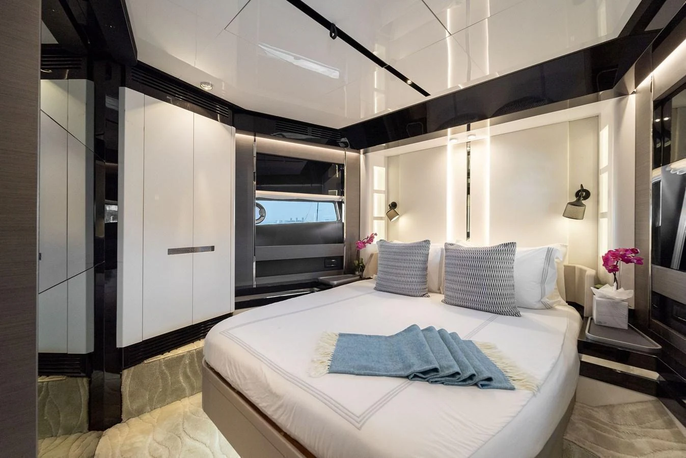 The stateroom features a luxurious bed with elegant decor and modern lighting. aboard OCEAN'S SE7EN Yacht for Sale