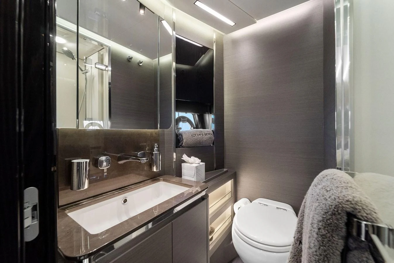 A modern and sleek bathroom with high-end fixtures and elegant lighting. aboard OCEAN'S SE7EN Yacht for Sale