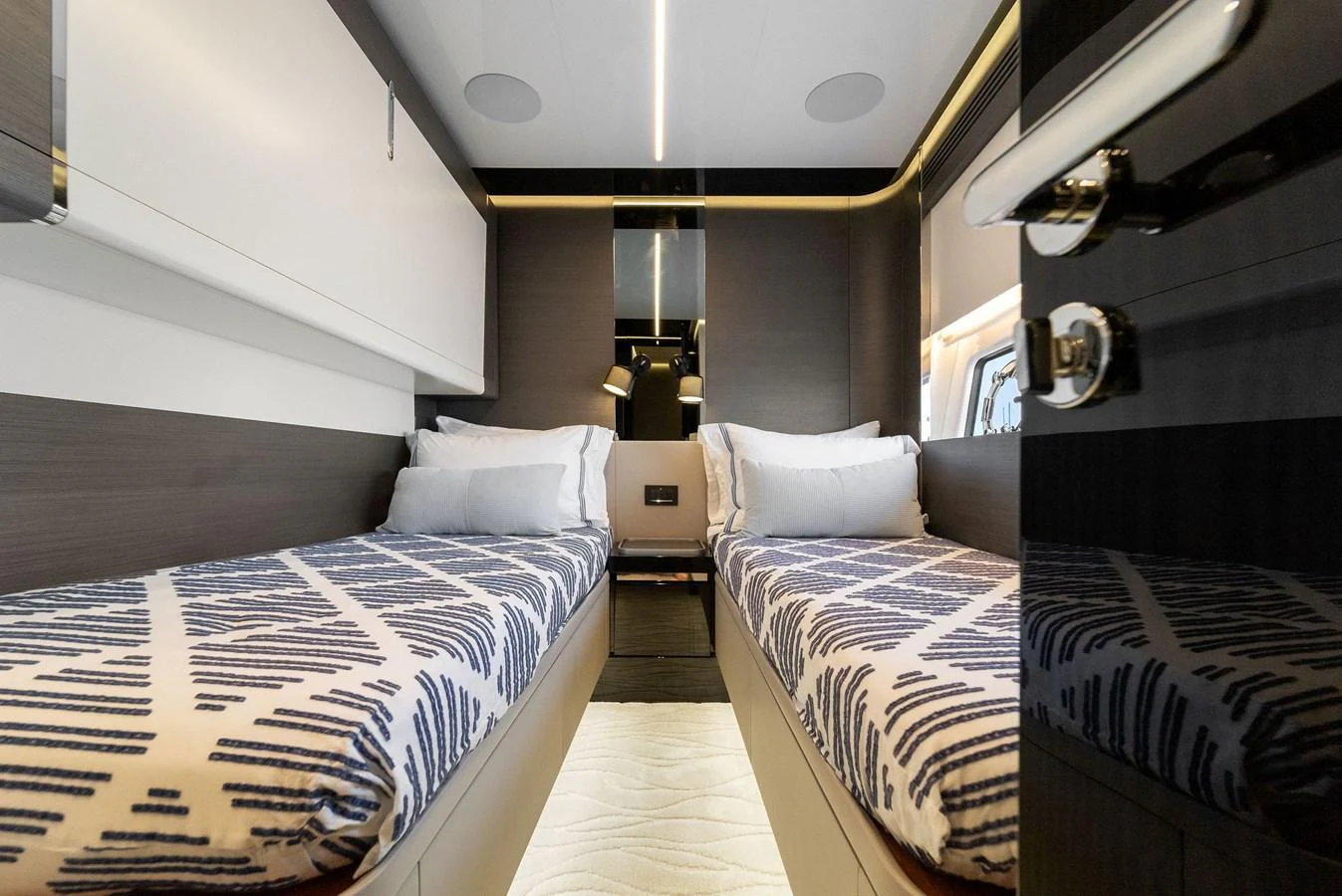 The twin stateroom features two comfortable single beds with stylish bedding and modern decor. aboard OCEAN'S SE7EN Yacht for Sale
