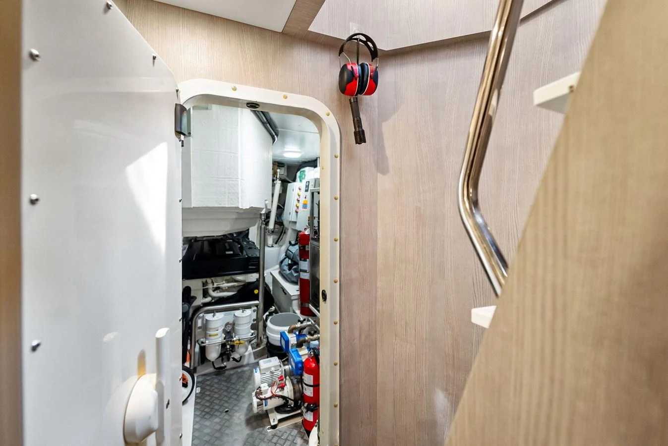A well-maintained engine room with visible machinery and safety equipment. aboard OCEAN'S SE7EN Yacht for Sale