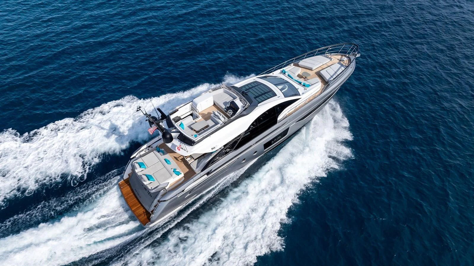 A sleek and modern yacht cruises swiftly through the open water, showcasing its luxurious design and spacious decks. aboard OCEAN'S SE7EN Yacht for Sale