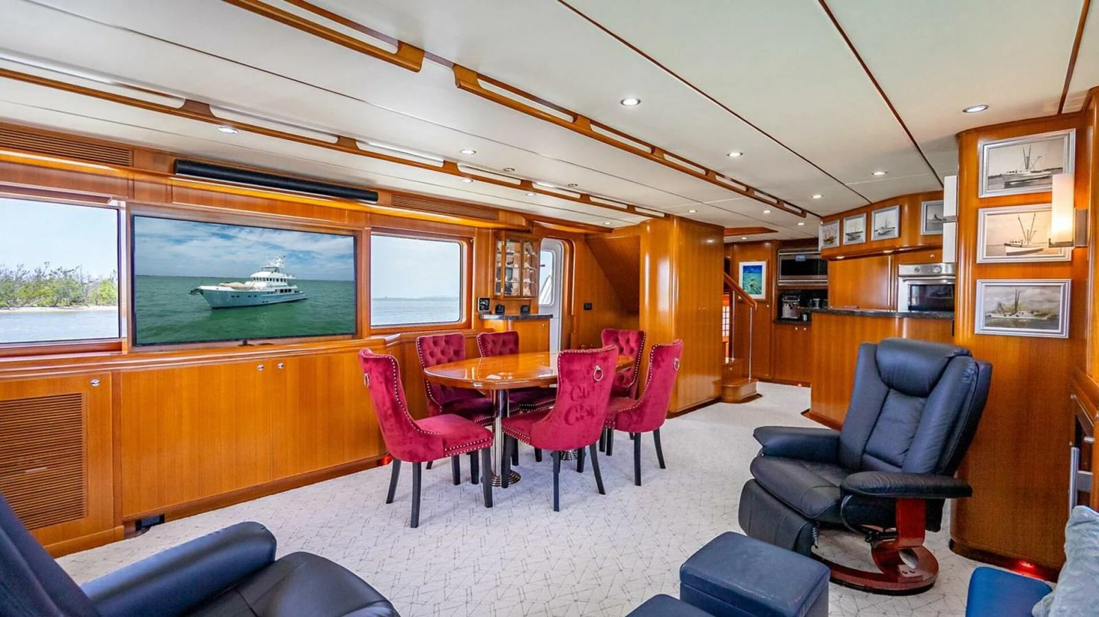 The salon features luxurious seating, a dining area, and large windows for natural light. aboard TAKE 5 Yacht for Sale
