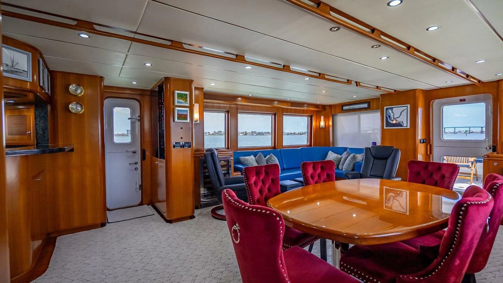 The yacht's salon features luxurious seating and a dining area with elegant decor. aboard TAKE 5 Yacht for Sale