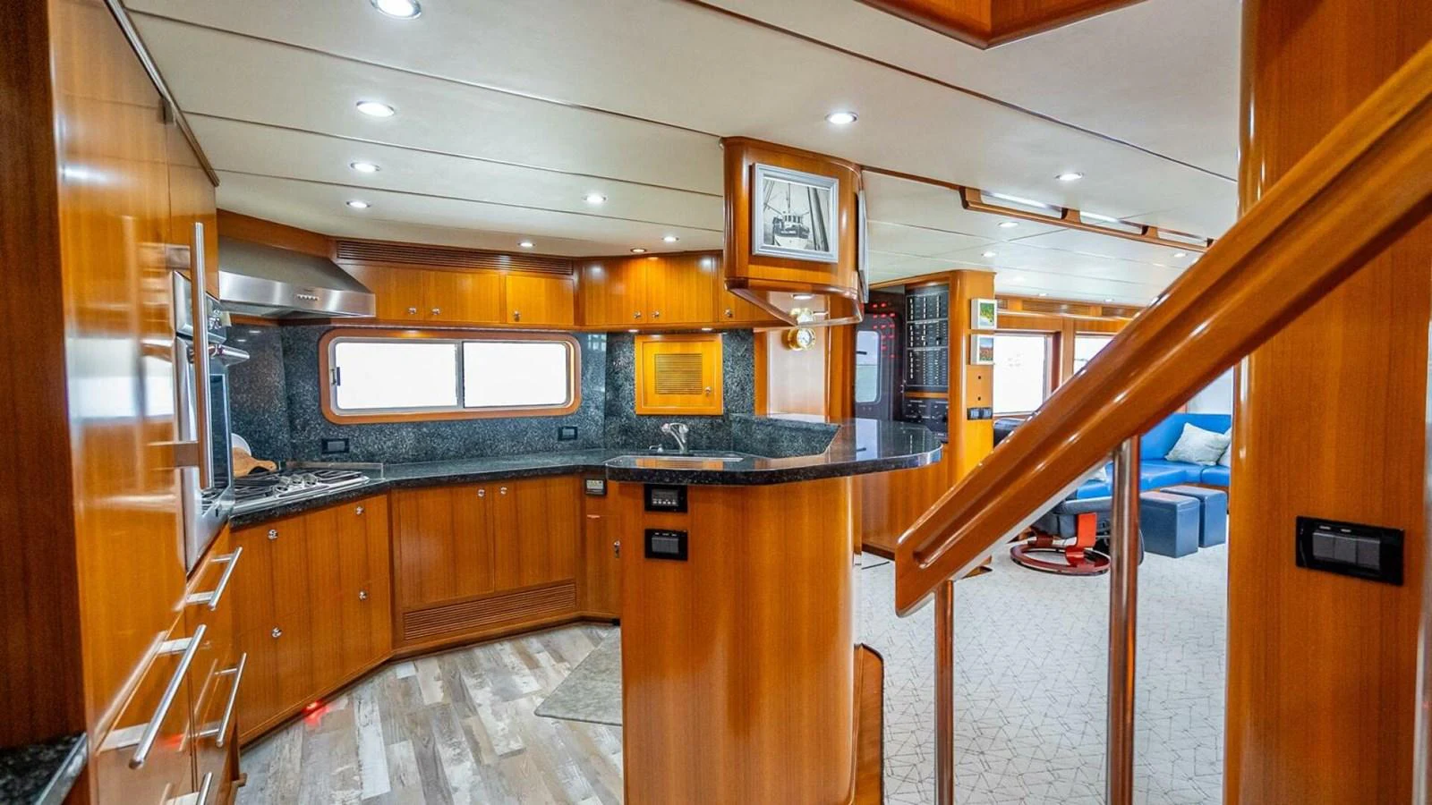 The yacht's galley features warm wood finishes, modern appliances, and ample counter space. aboard TAKE 5 Yacht for Sale