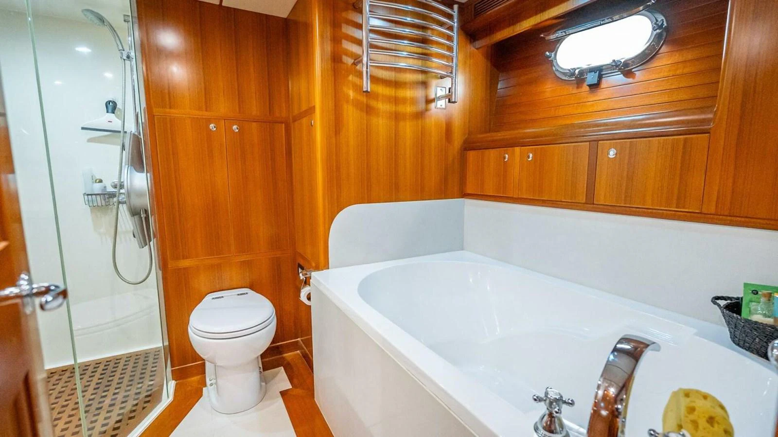 This yacht features a luxurious bathroom with a spacious bathtub and elegant wooden finishes. aboard TAKE 5 Yacht for Sale