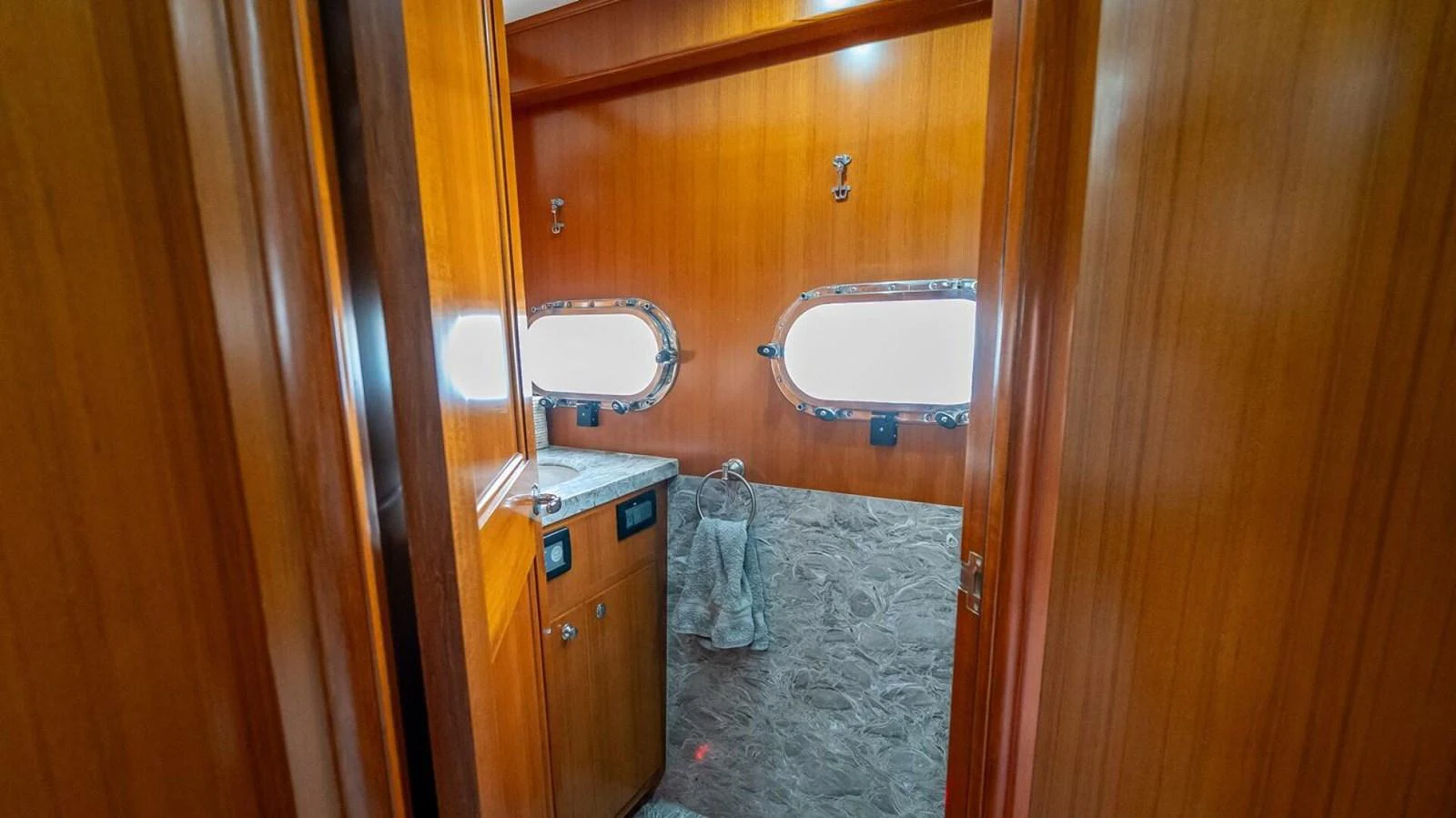 A cozy yacht bathroom with wooden paneling and marble countertops. aboard TAKE 5 Yacht for Sale