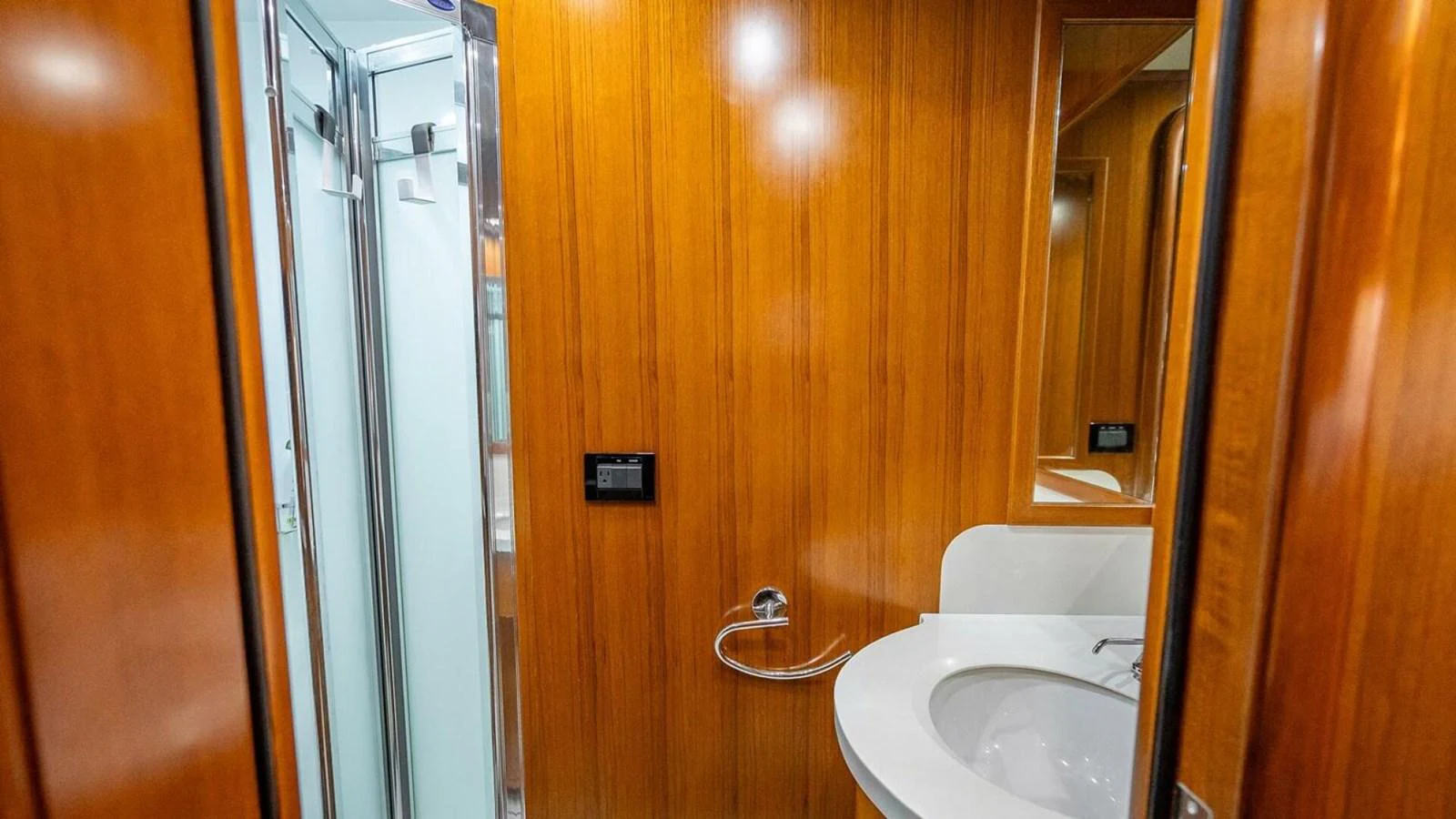 The yacht's bathroom features elegant wood paneling and modern fixtures. aboard TAKE 5 Yacht for Sale