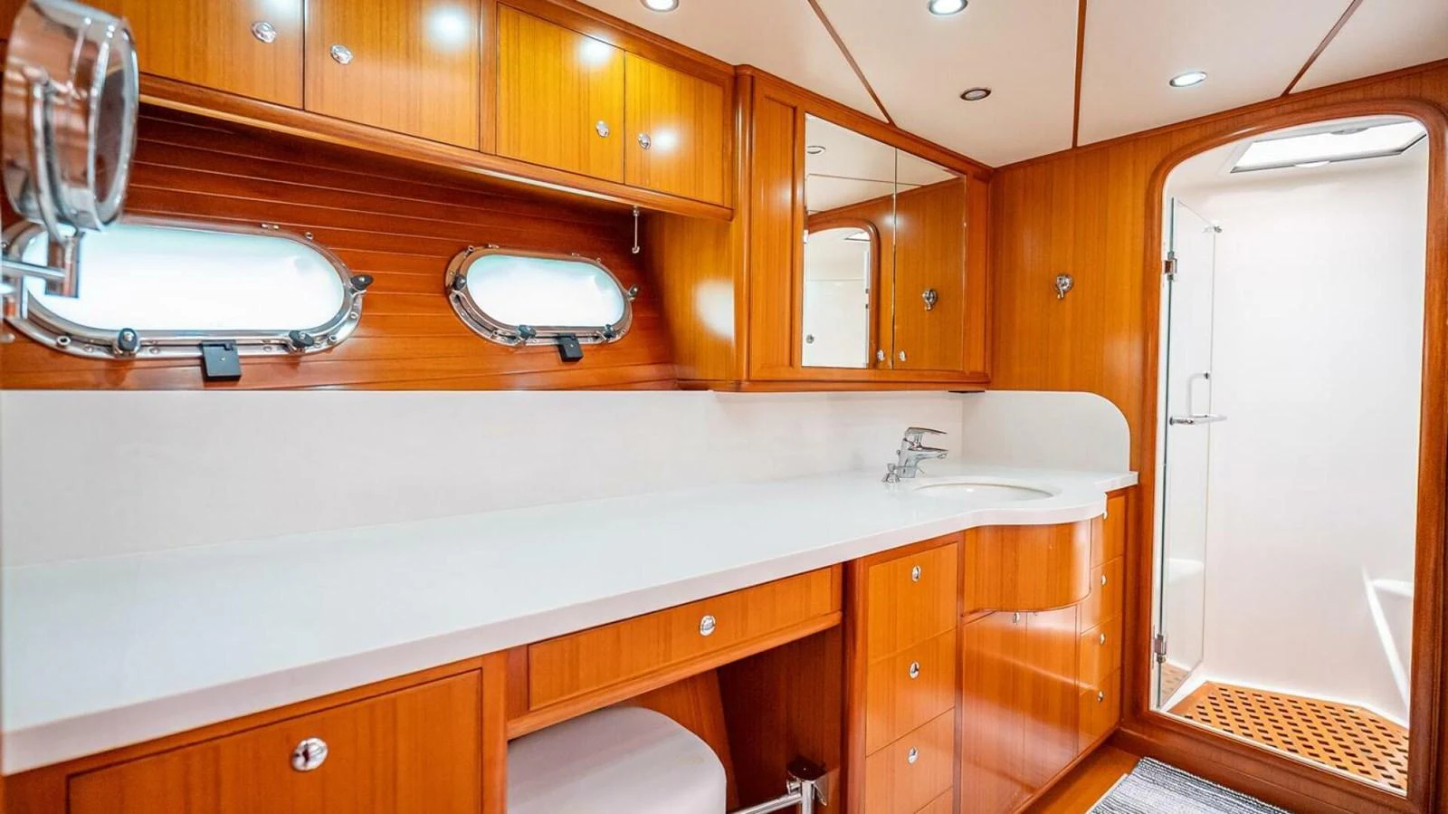 The yacht's bathroom features elegant wooden cabinetry and modern fixtures. aboard TAKE 5 Yacht for Sale