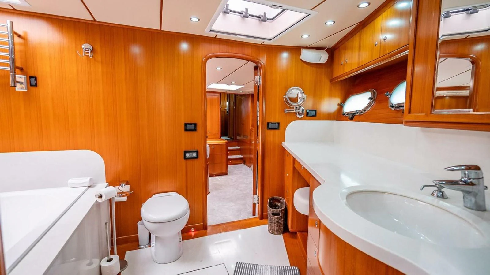 The yacht's bathroom features elegant wooden cabinetry and modern fixtures, creating a warm and inviting atmosphere. aboard TAKE 5 Yacht for Sale