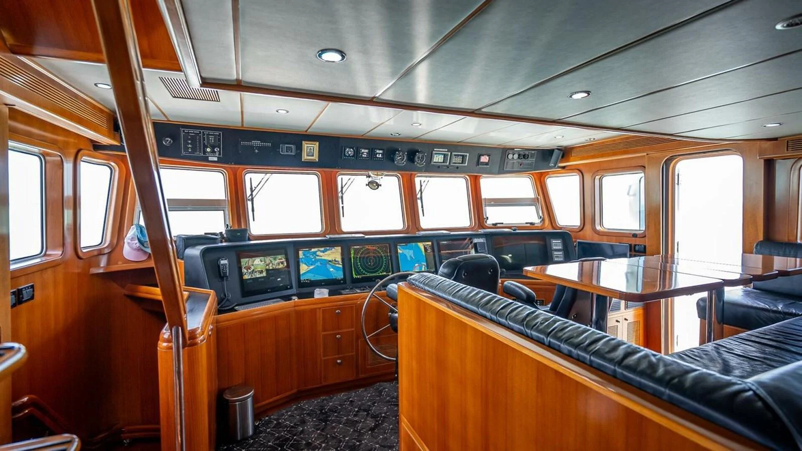 The helm station features state-of-the-art navigation equipment and luxurious wood finishes. aboard TAKE 5 Yacht for Sale
