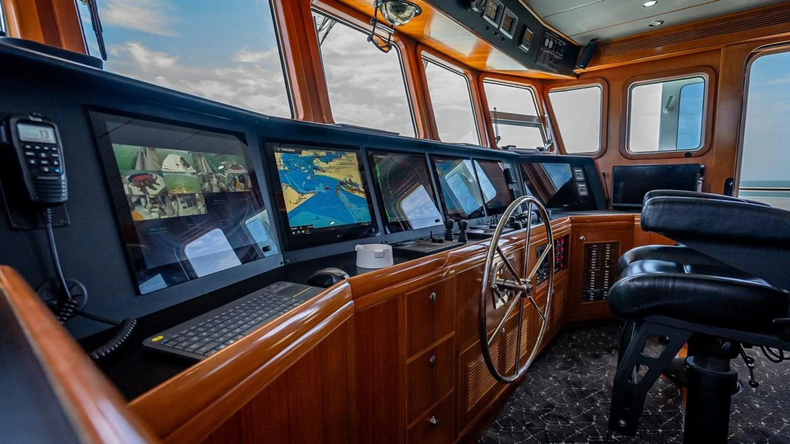 The helm features advanced navigation equipment and a panoramic view. aboard TAKE 5 Yacht for Sale
