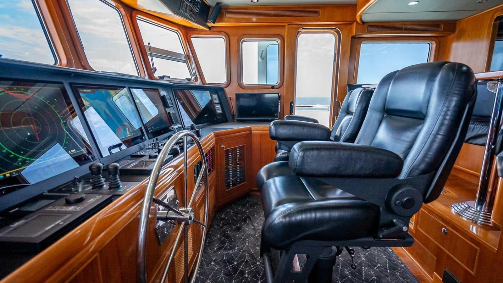 The helm station features luxurious leather chairs and state-of-the-art navigation equipment. aboard TAKE 5 Yacht for Sale