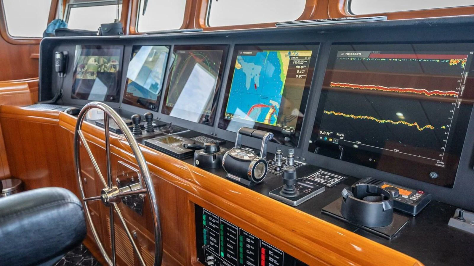 The helm features advanced navigation equipment and a sleek design. aboard TAKE 5 Yacht for Sale