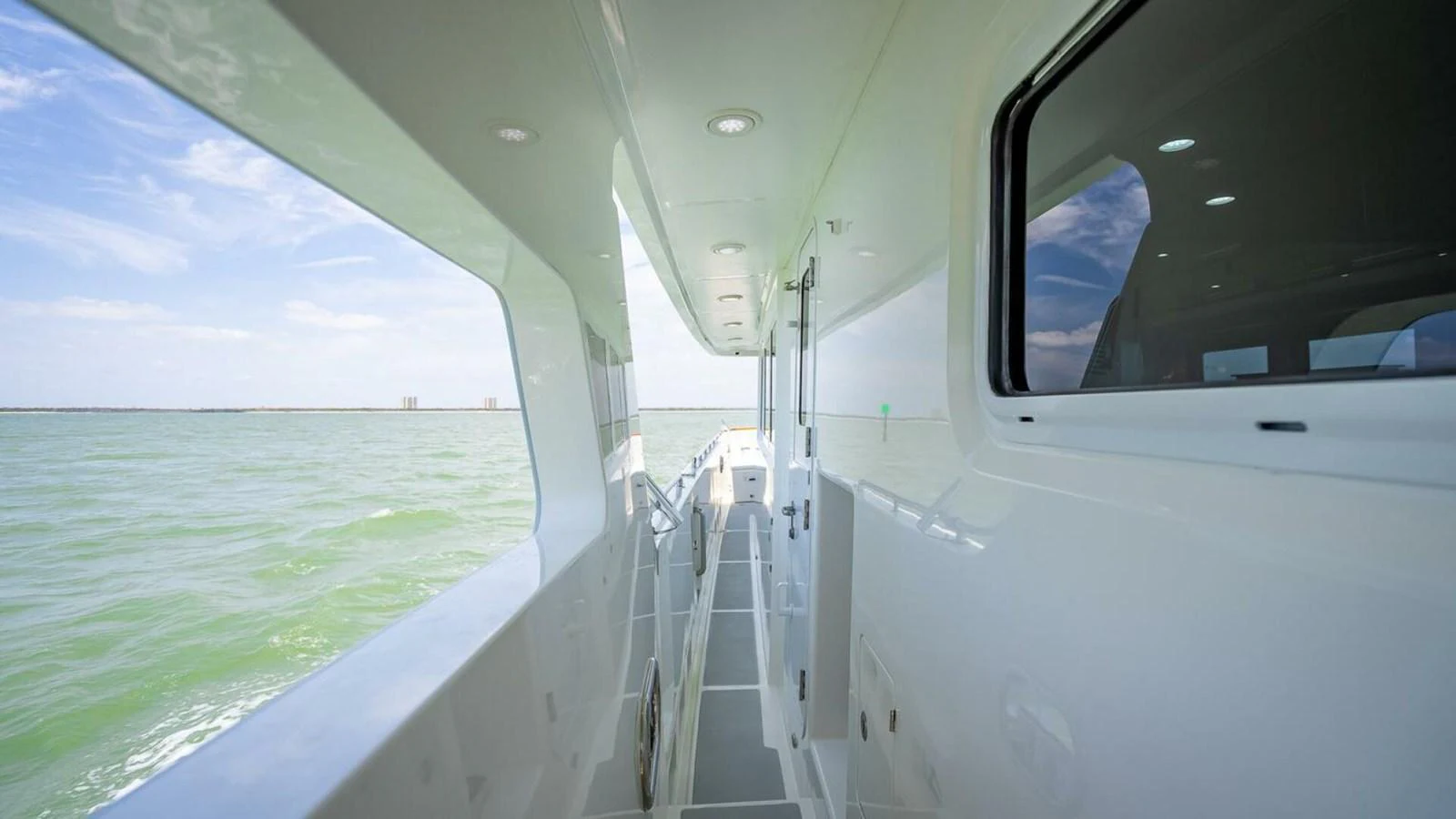 The side deck of the yacht offers a sleek passageway with views of the surrounding water. aboard TAKE 5 Yacht for Sale