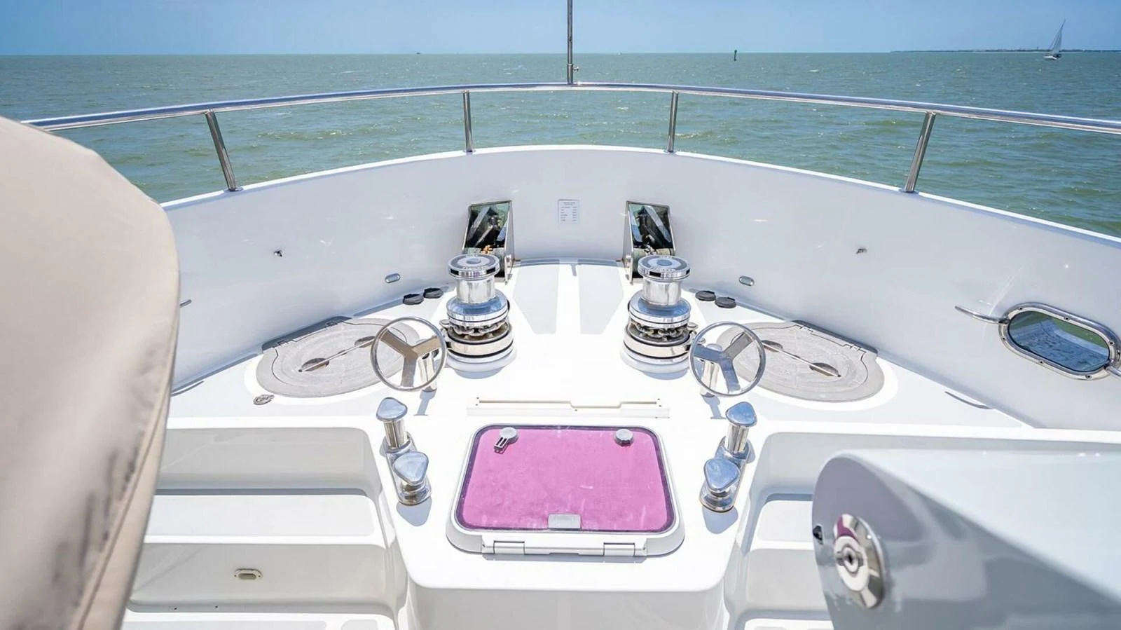 The bow of the yacht features a clean and well-equipped anchor handling area with a stunning view of the open sea. aboard TAKE 5 Yacht for Sale