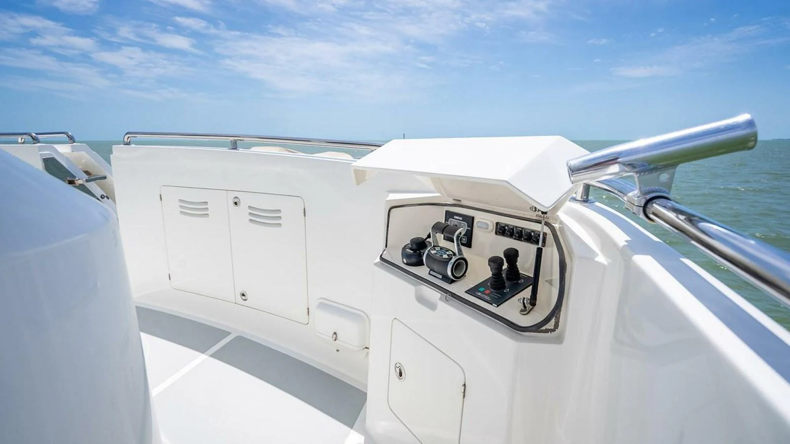The helm station features modern controls and a sleek design, offering a commanding view of the sea. aboard TAKE 5 Yacht for Sale