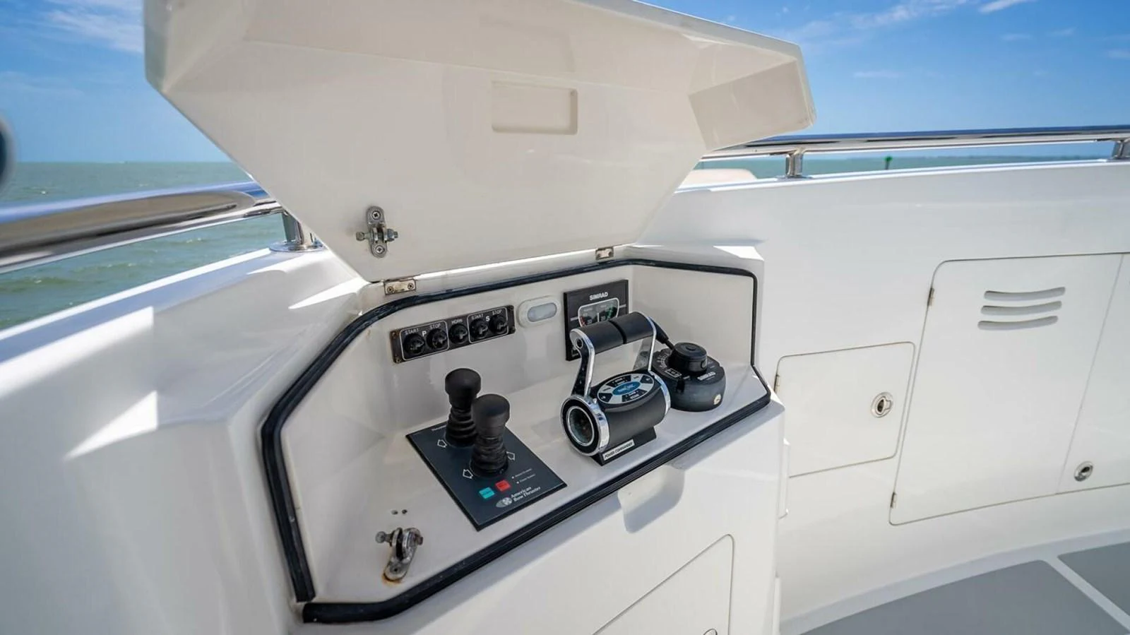 The yacht's helm station features modern controls and a clean, functional design. aboard TAKE 5 Yacht for Sale